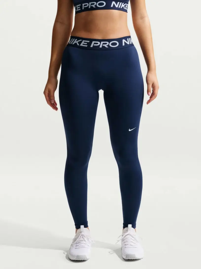 Woman wearing navy leggings with Nike branding