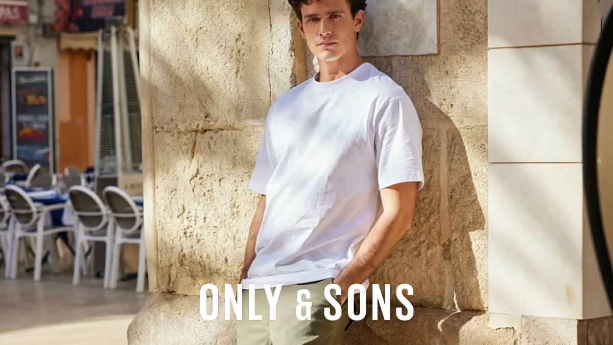 Man wearing a white T-shirt and plain chinos