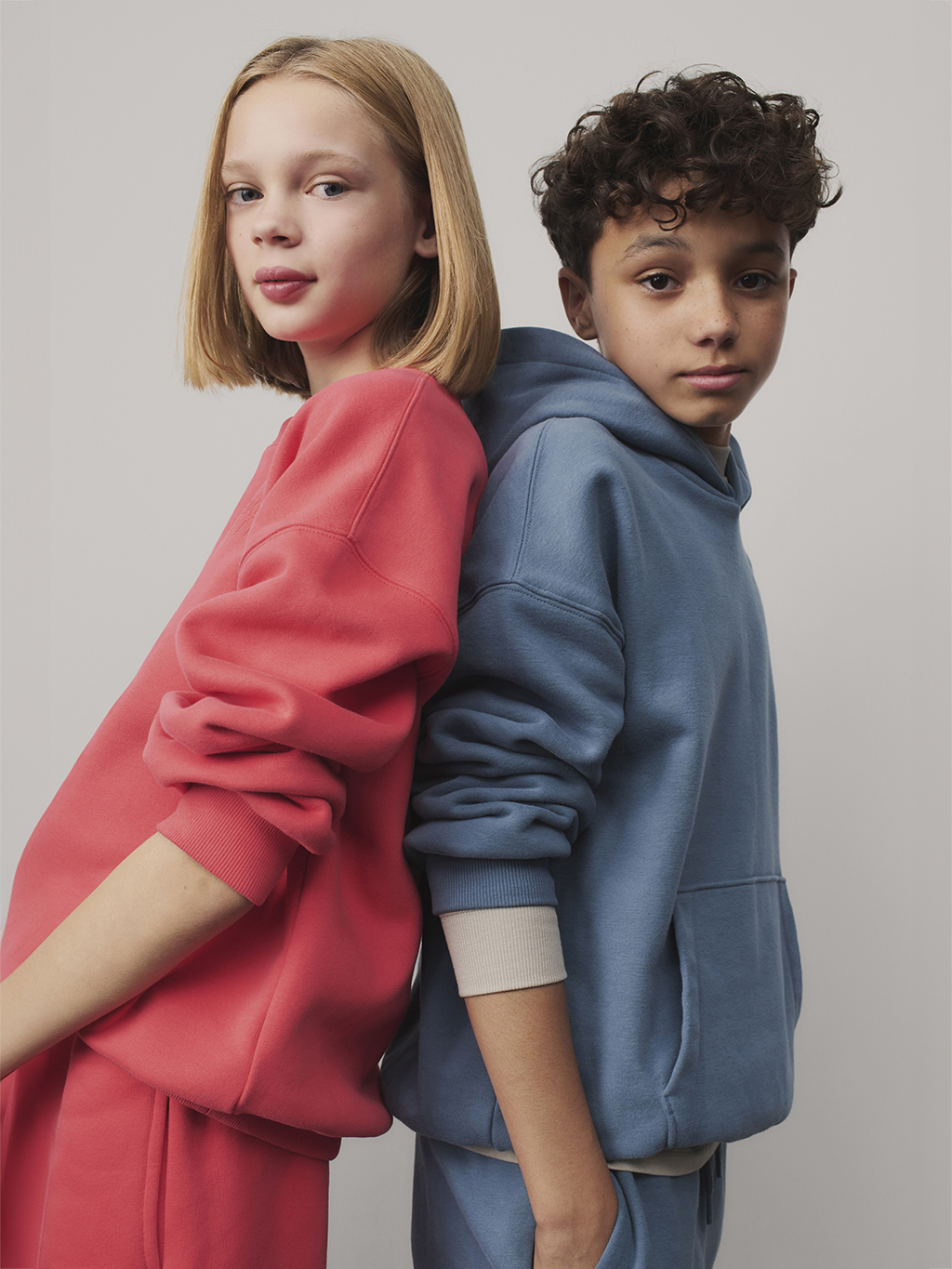 Girl and boy wearing colourful matching loungewear sets