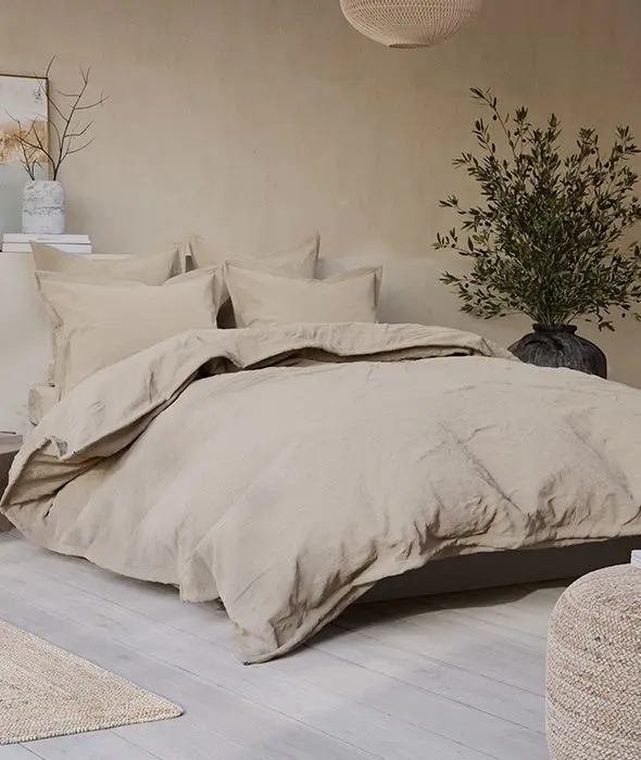 Bed made up with light brown pure-linen bedding