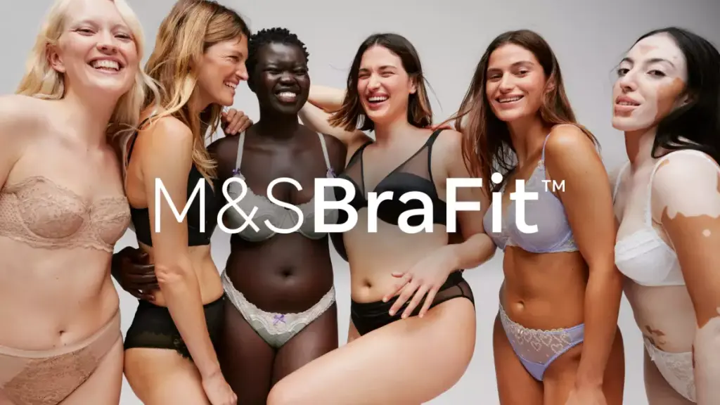 Group of women wearing bras and smiling.