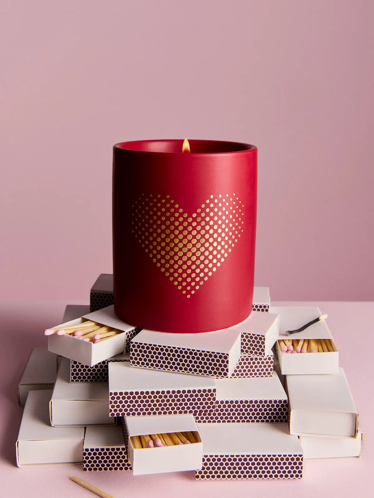 Red Kelly Hoppin candle on top of match boxes