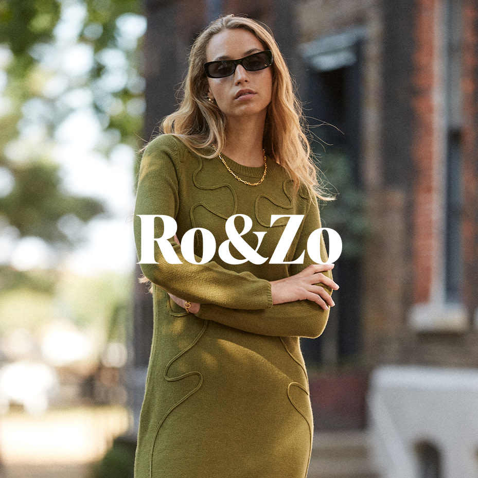 Woman wearing Ro&Zo green dress and black sunglasses