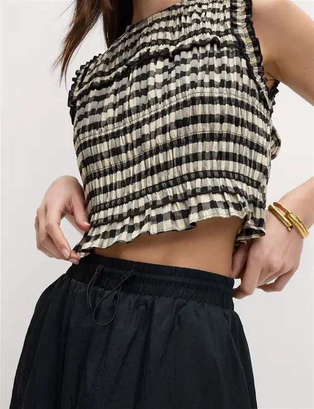 woman wearing black and white top in gingham pattern