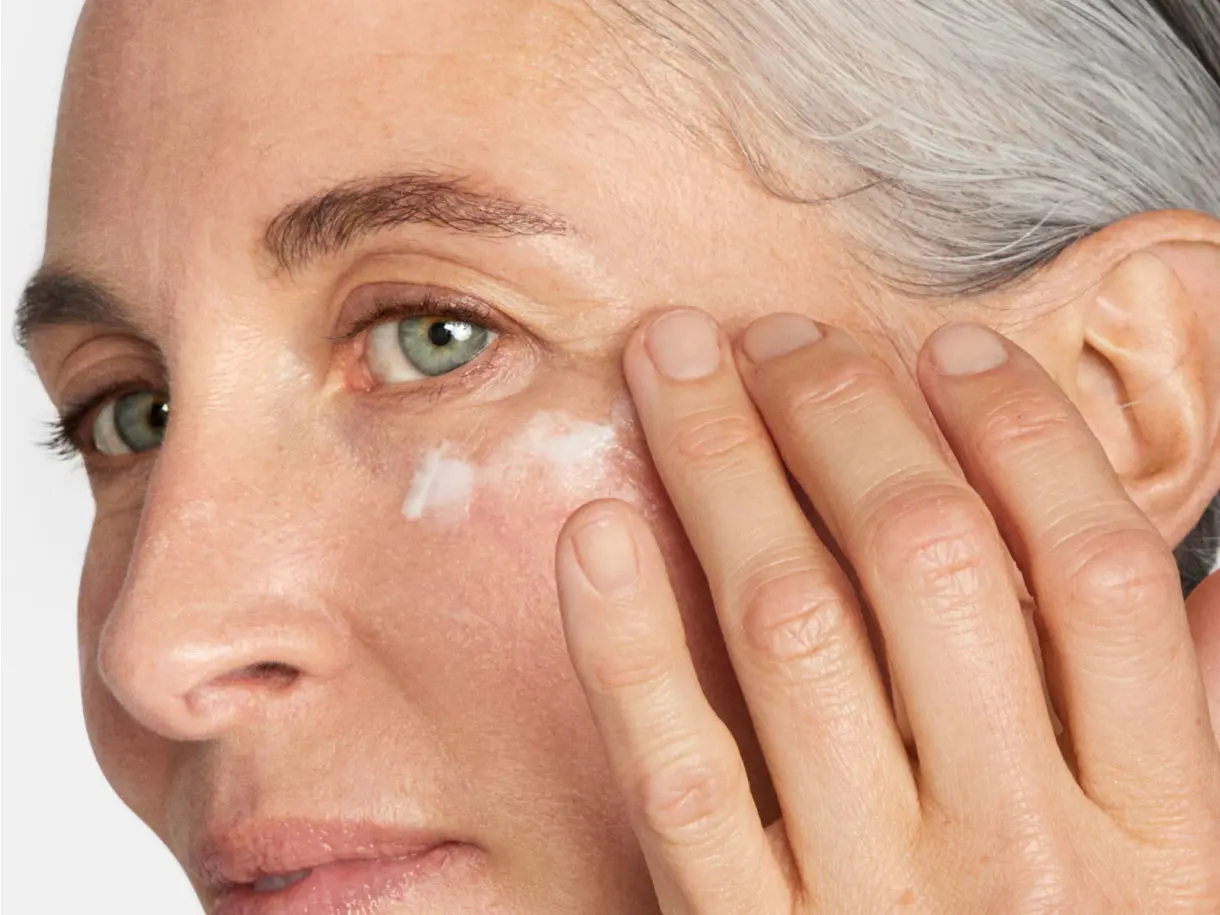 Woman applying eye cream