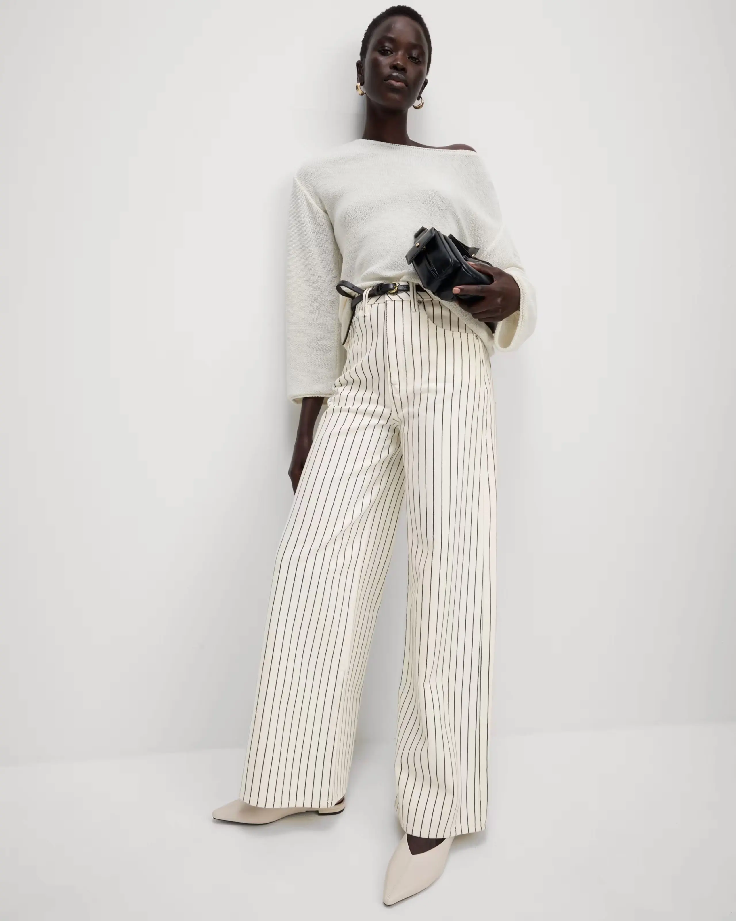 Woman wearing striped trousers and a cream top