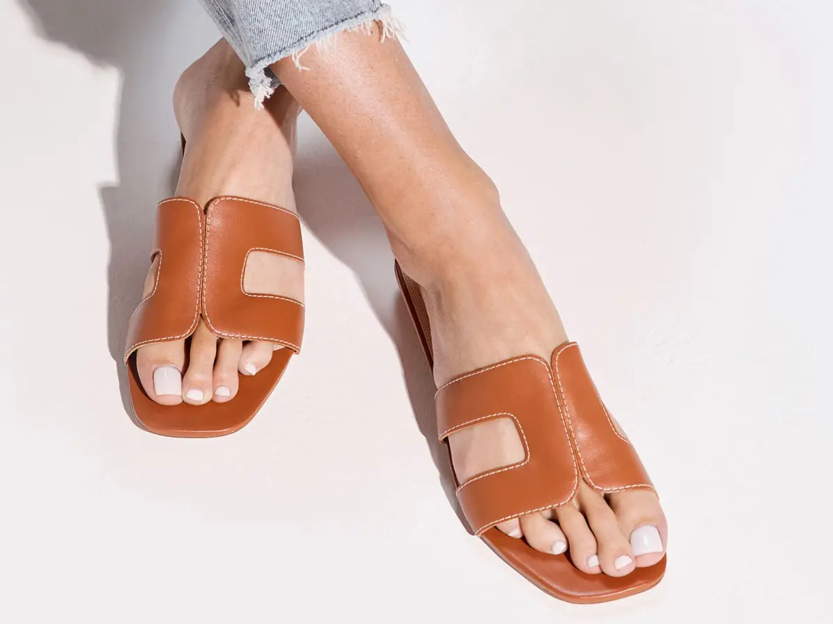 Woman wearing brown sandals