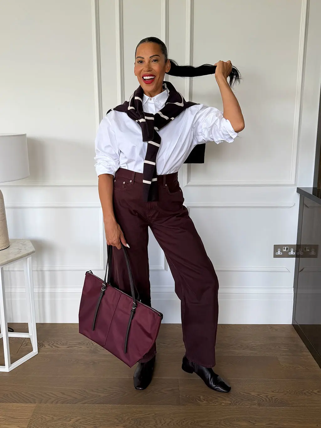 Karen Williams in white shirt and burgundy trousers