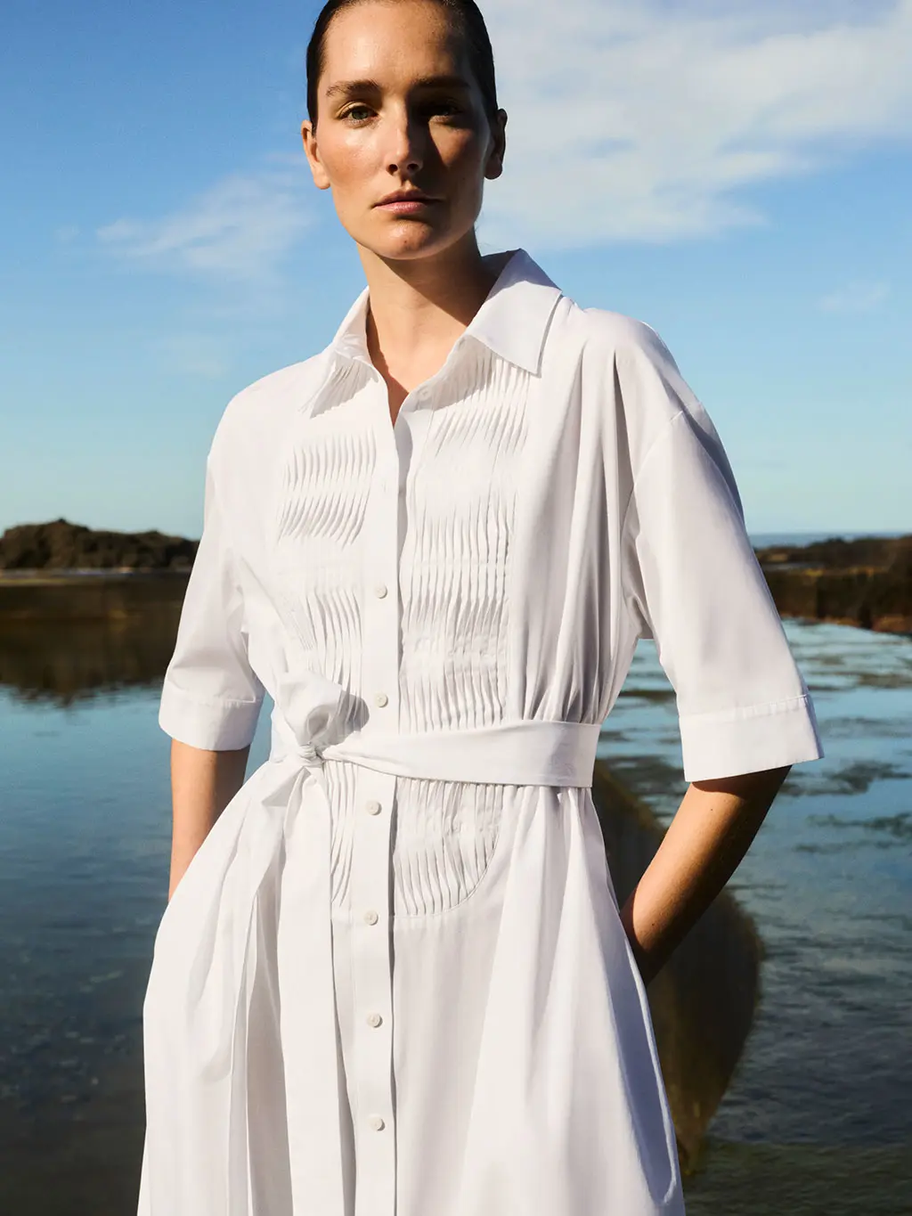 Woman in white cotton shirt dress