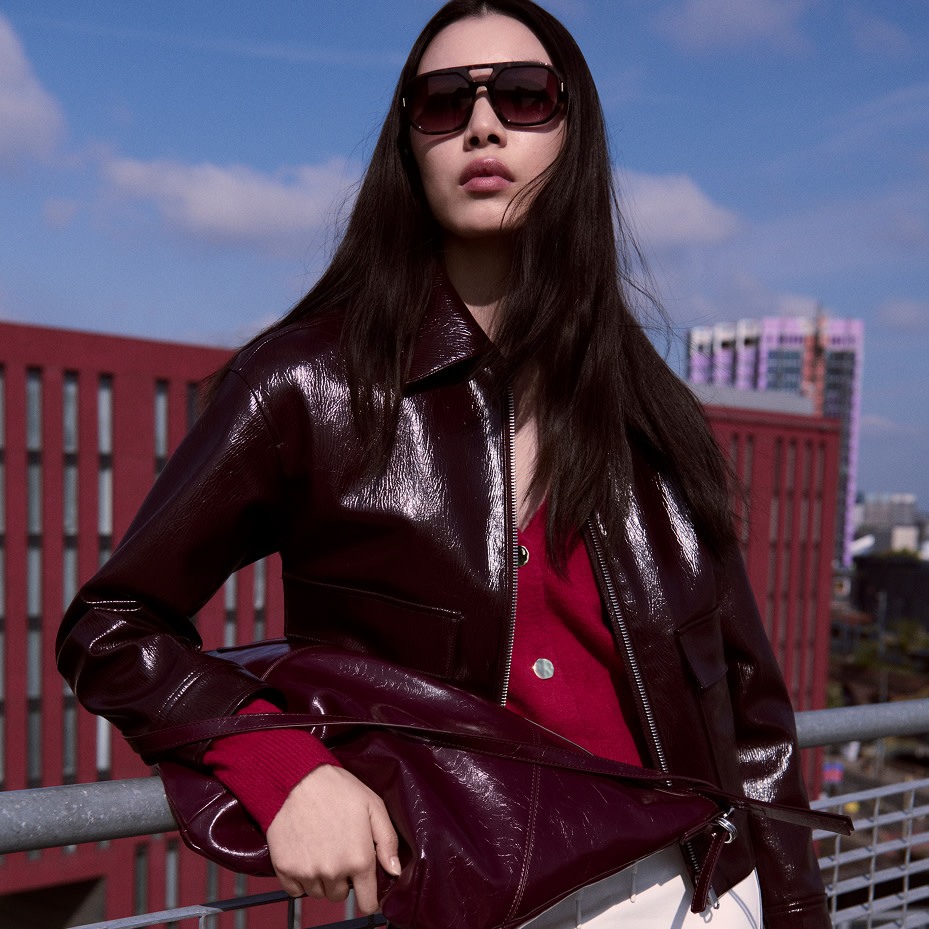 Woman wearing a leather jacket and red top