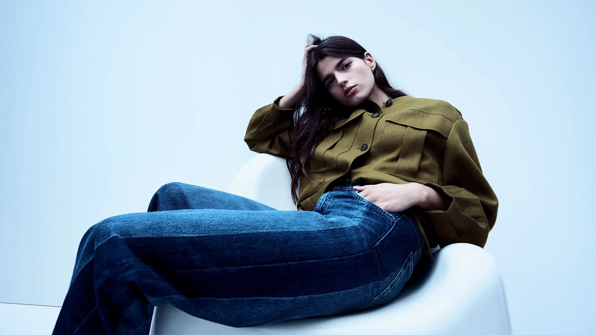 Woman wearing utility jacket with blue jeans