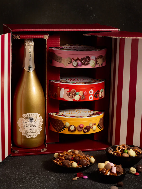 Gold bottle of Prosecco and three tins of snacks
