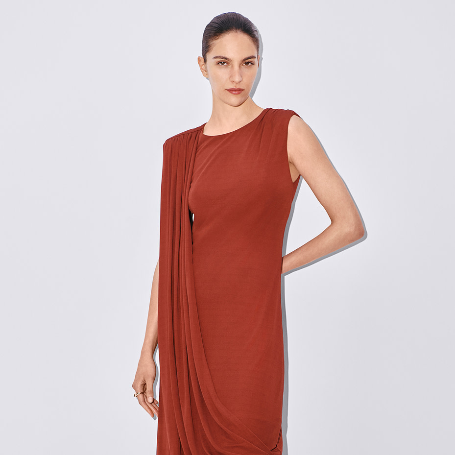 Woman wearing red dress with draping detail