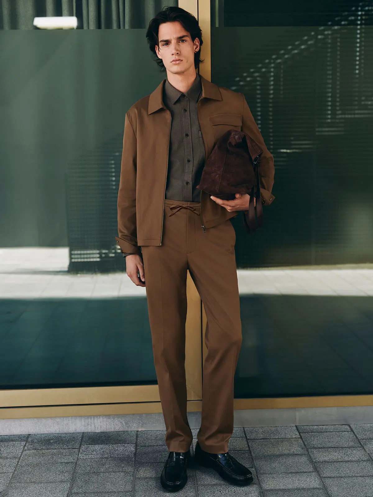 Man wearing brown overshirt with matching trousers