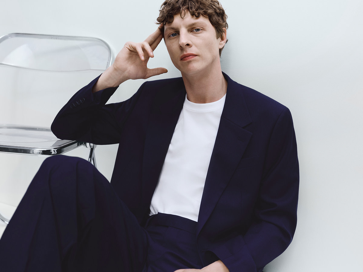 Man wearing white t-shirt and black jacket