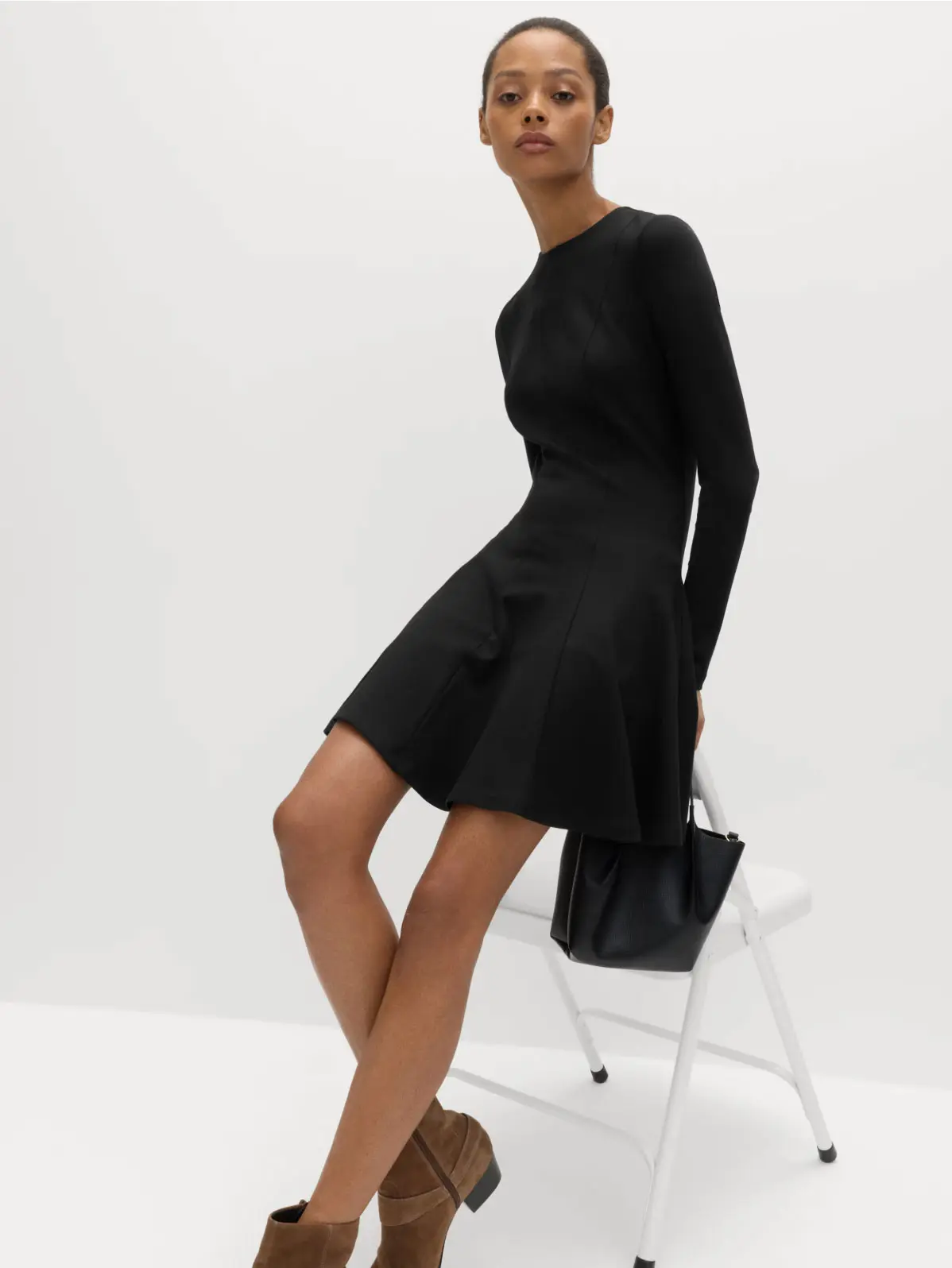 Woman wearing a knee-length black dress