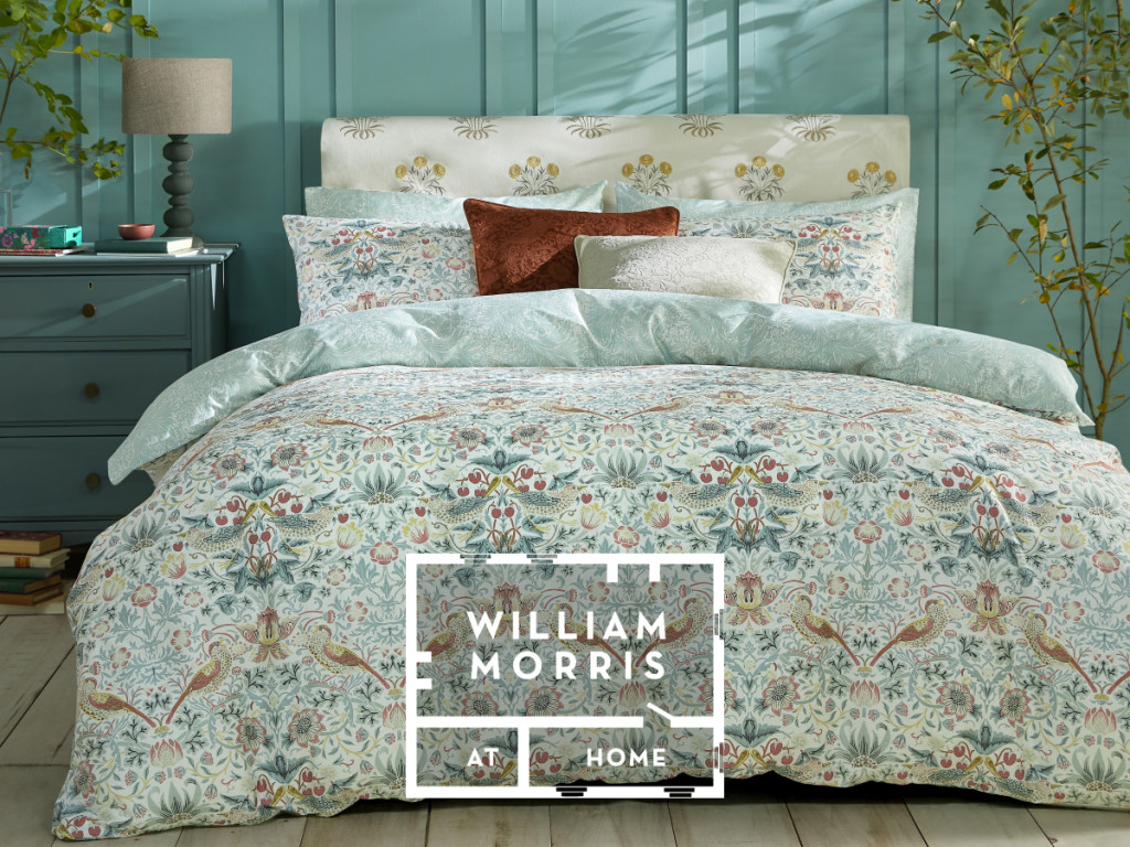 Bed made with pale blue floral bedding from the William Morris At Home collection. Shop William Morris At Home