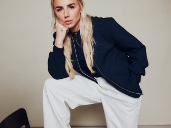 Chloe Kelly wearing white trousers and black blazer from the M&S | England collection