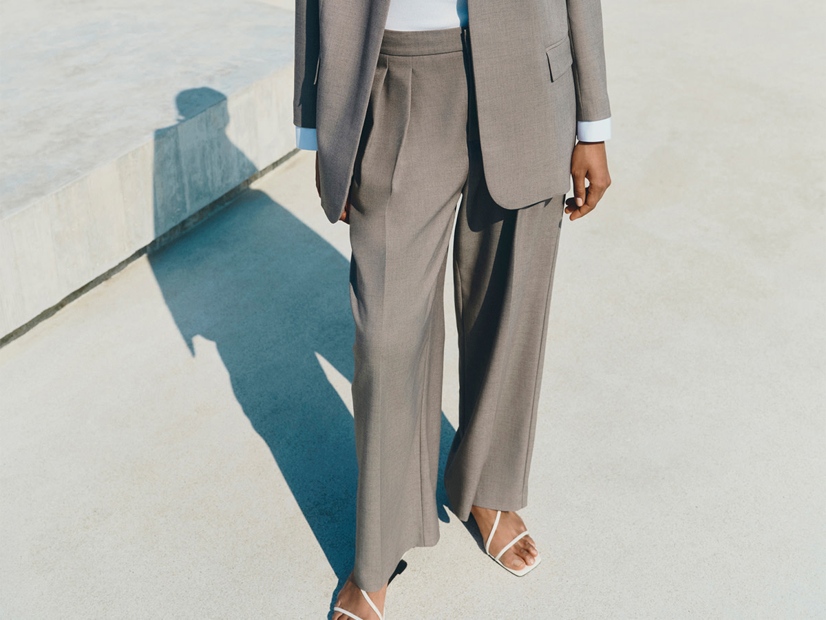 Woman wearing suit with white strappy heels