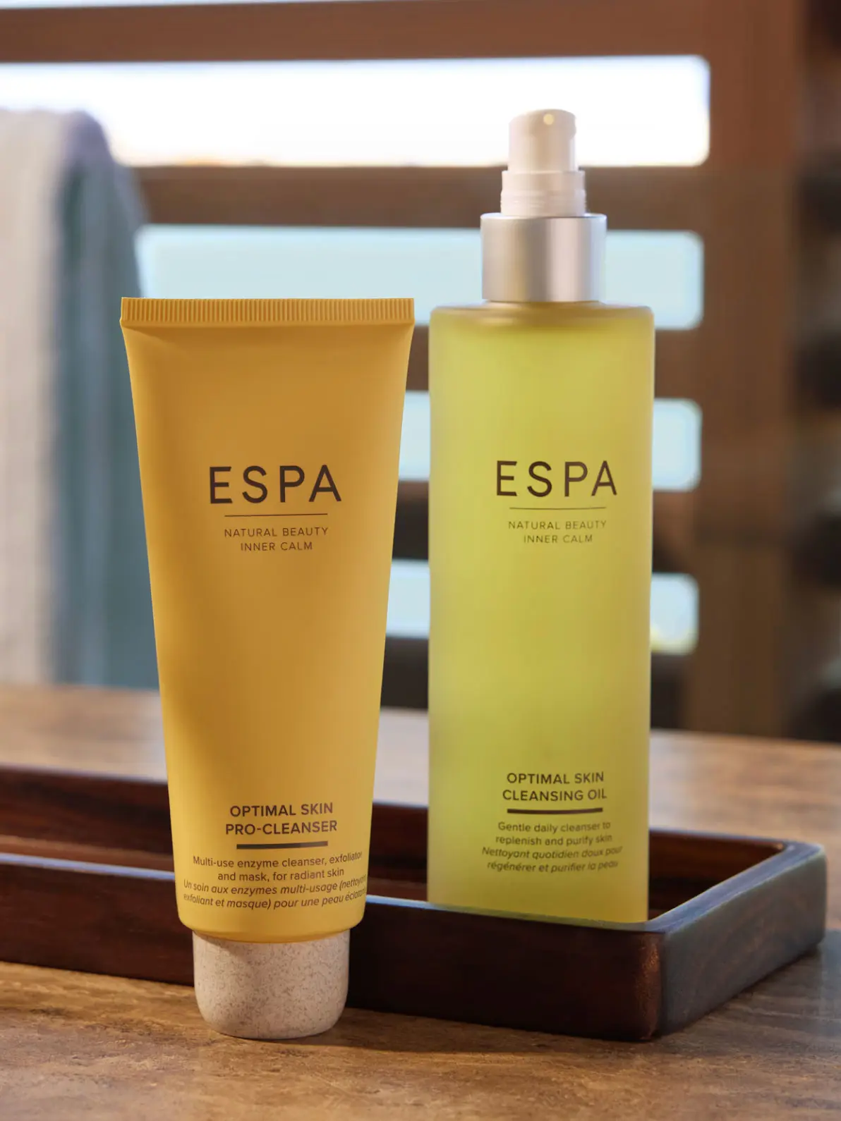 Two beauty products from ESPA. Orange tube bottle and pump bottle 