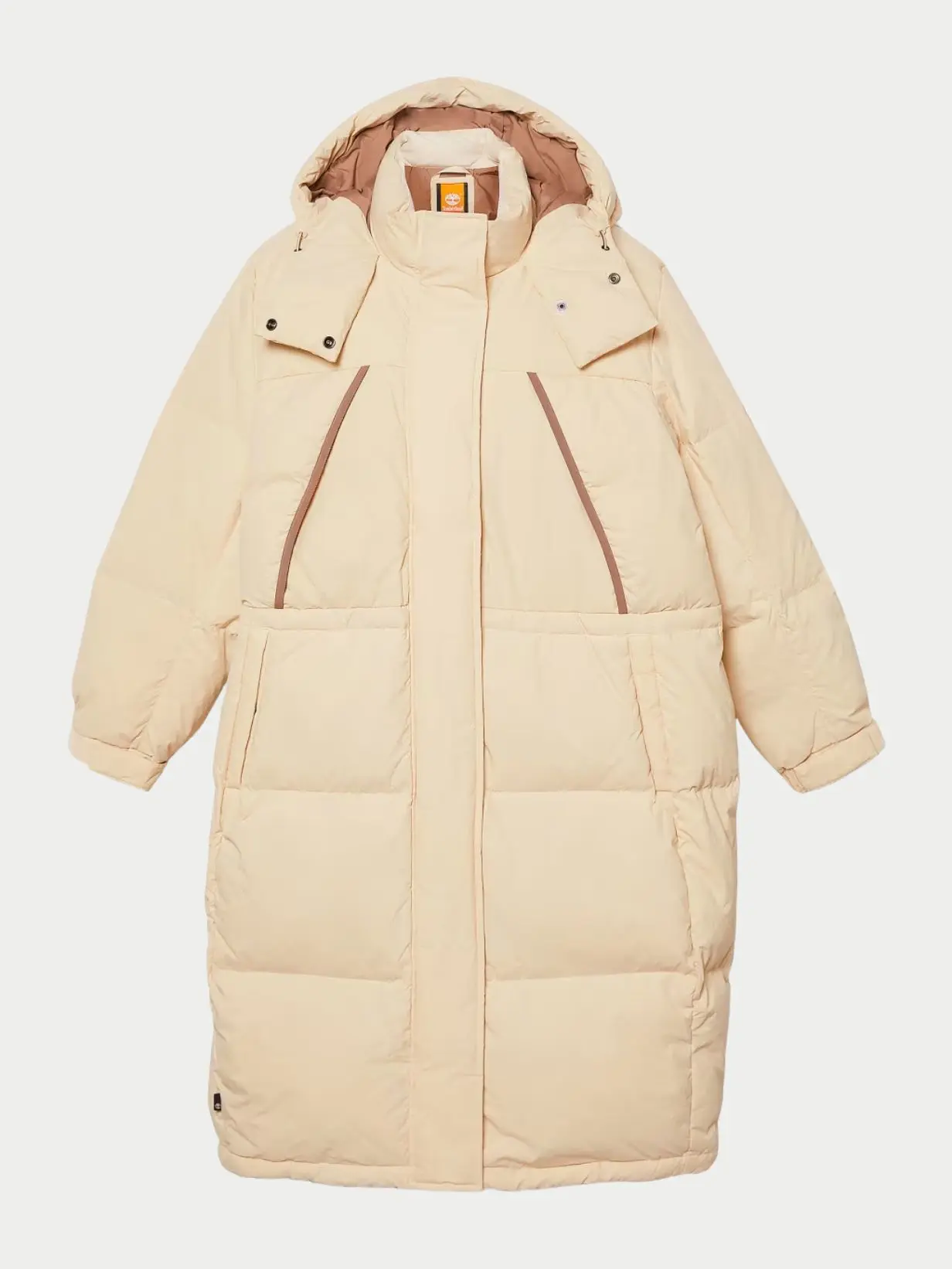 A cutout of a cream longline Timberland puffer jacket with a hood on a light background