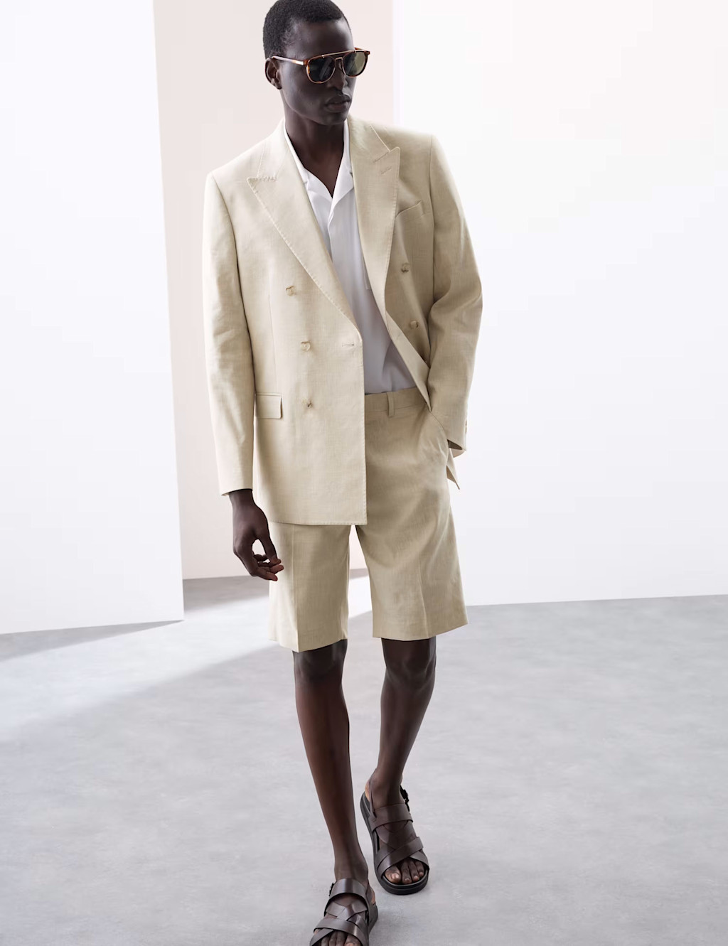 Man wearing cream linen shorts suit and white shirt at M&S