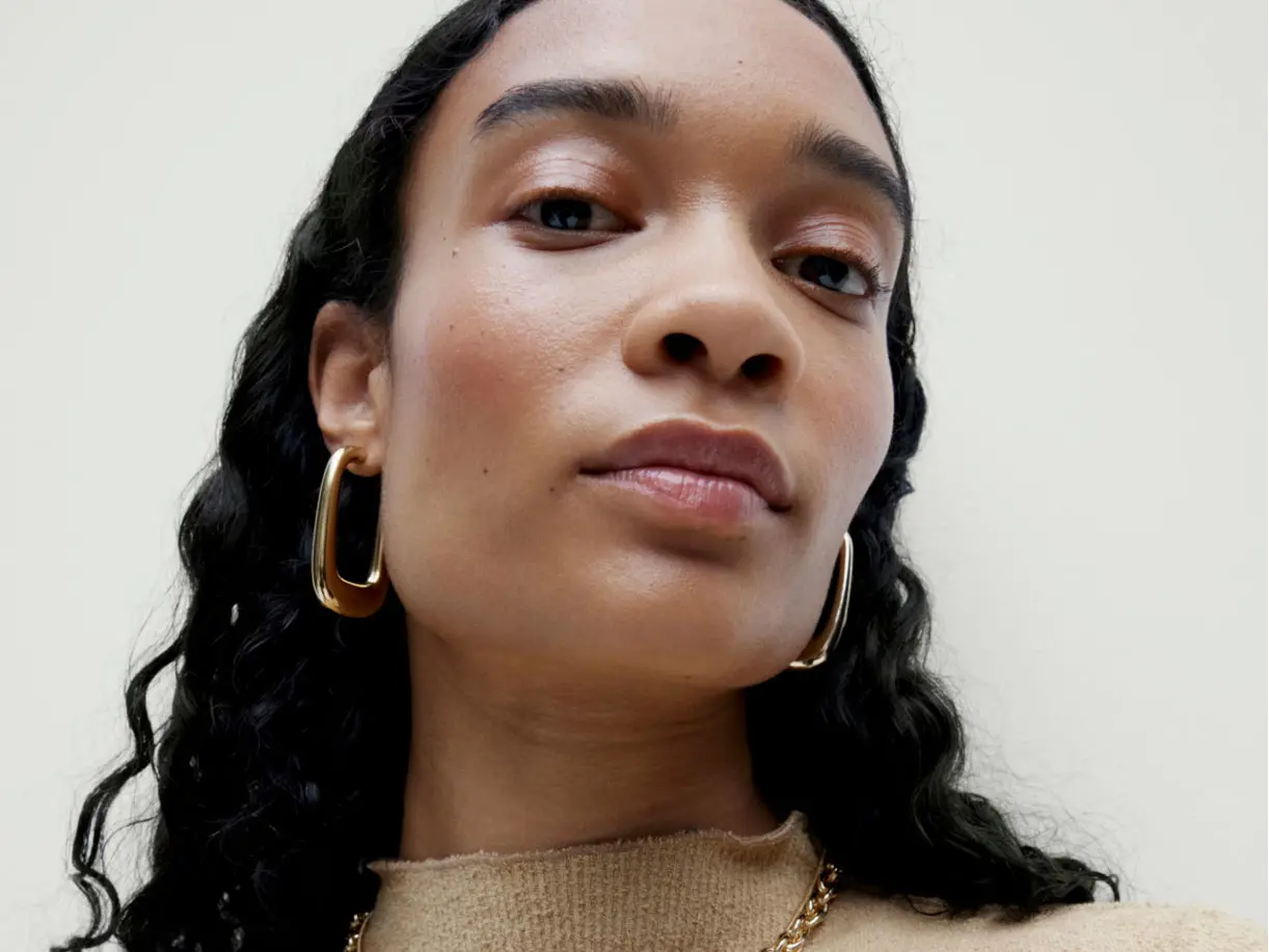 Woman wearing gold hoop earrings