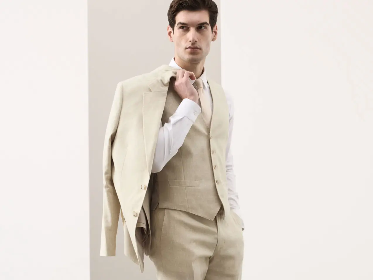 Man wearing stone-coloured suit 