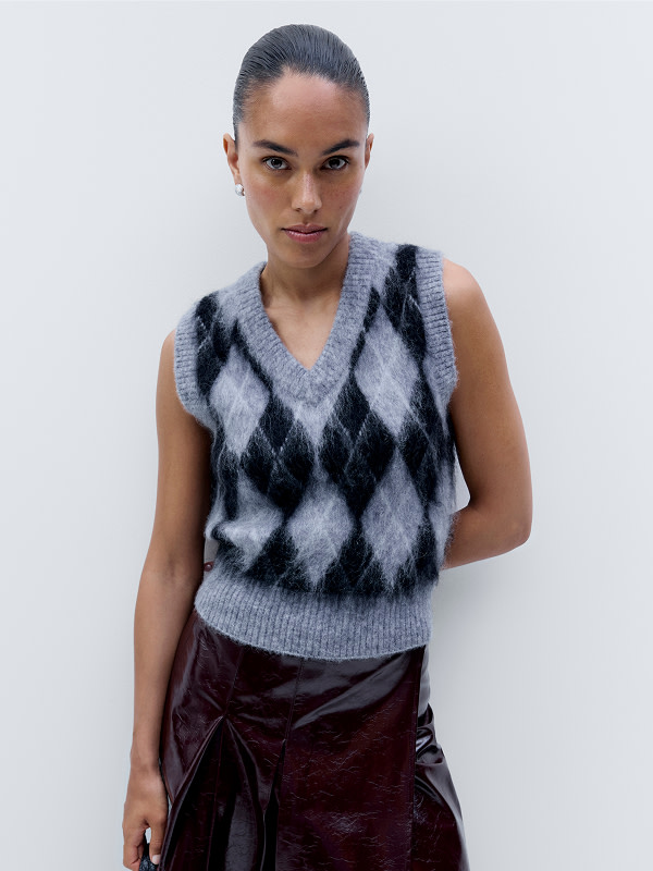 Woman in sweater vest