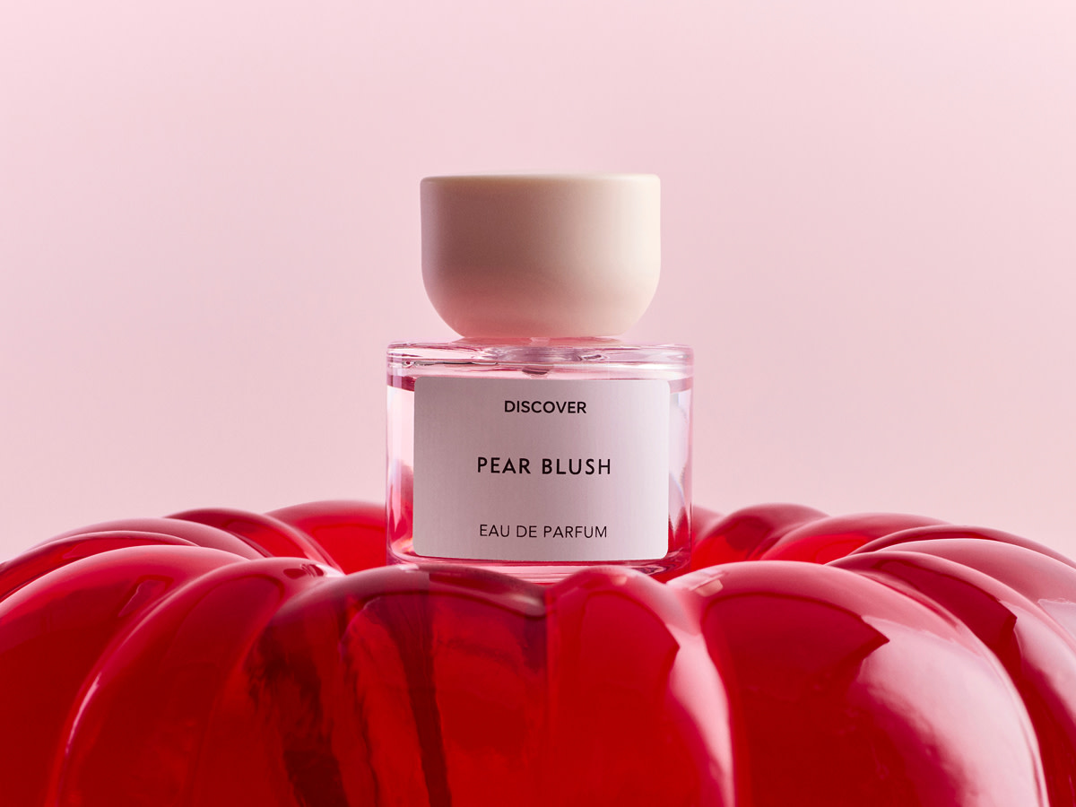 Bottle of perfume on red cushion