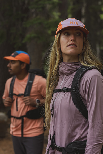 Models hiking in woods wearing Helly Hansen 