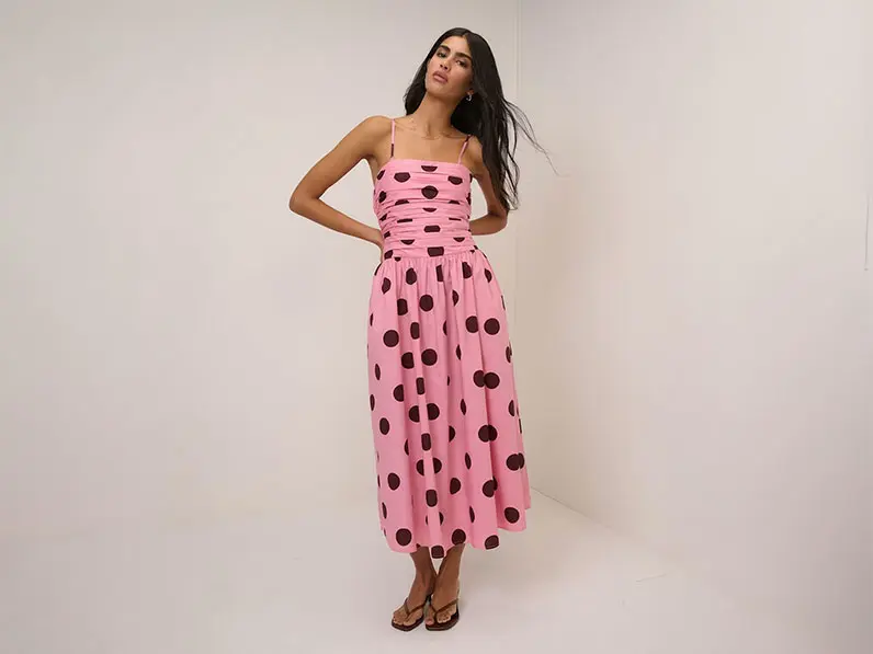 Woman wearing pink polka-dot midi dress