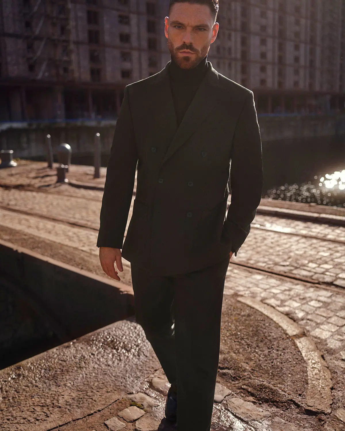 James Nelson Joyce wearing an olive green suit by Autograph