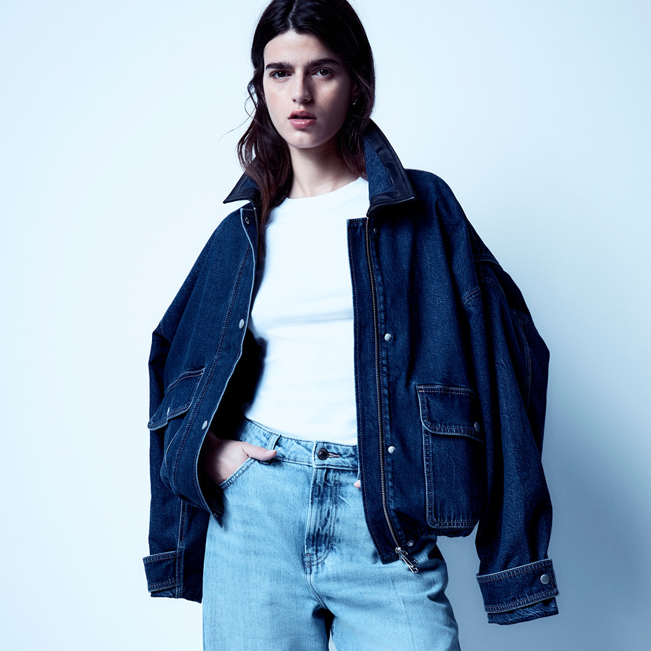 Woman wearing denim jacket, white top and jeans