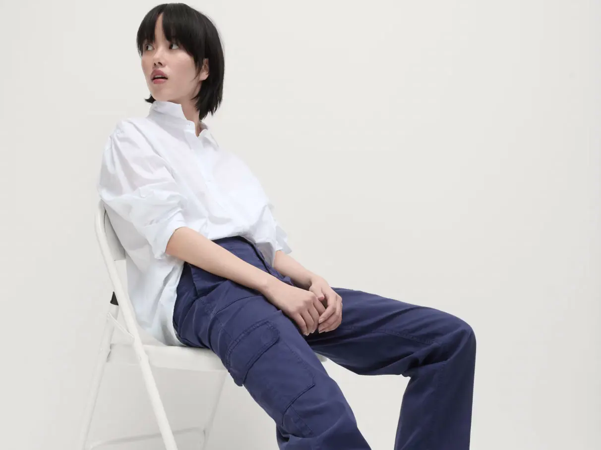Woman wearing white shirt and navy cargo trousers