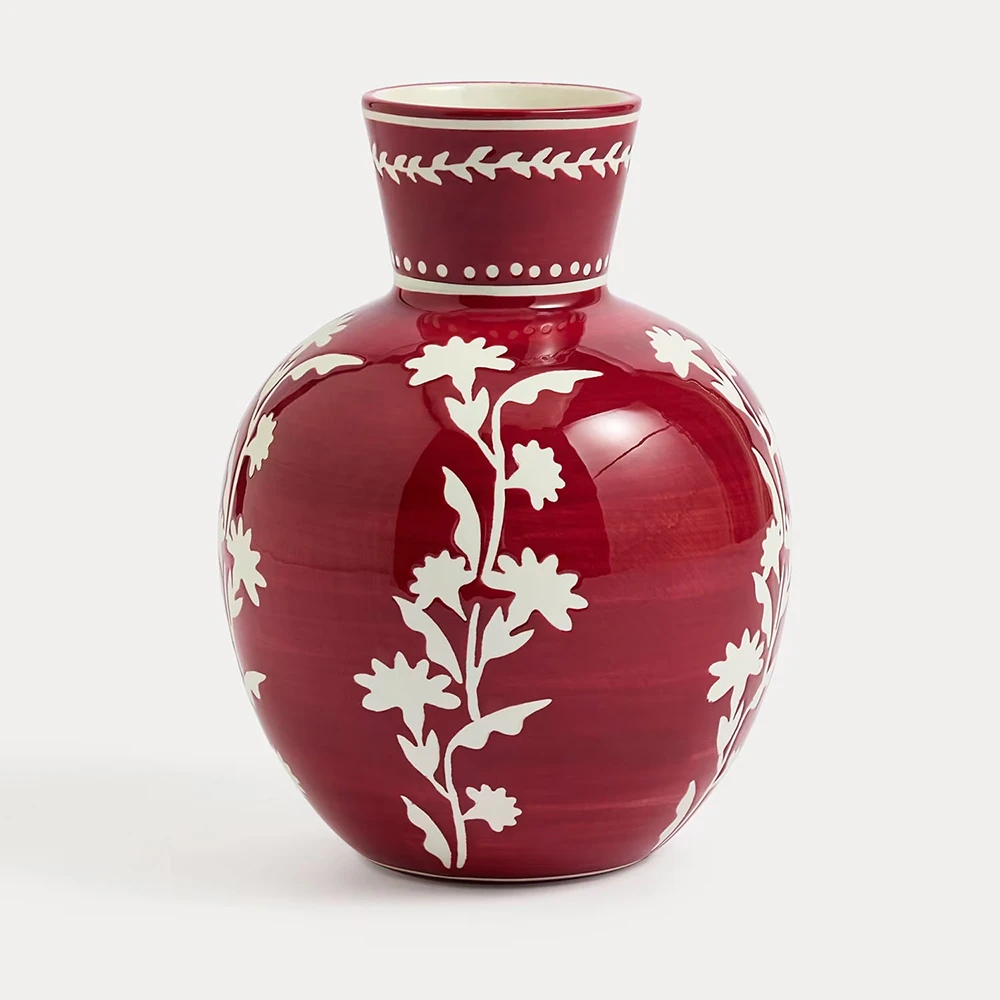 A red floral ceramic vase