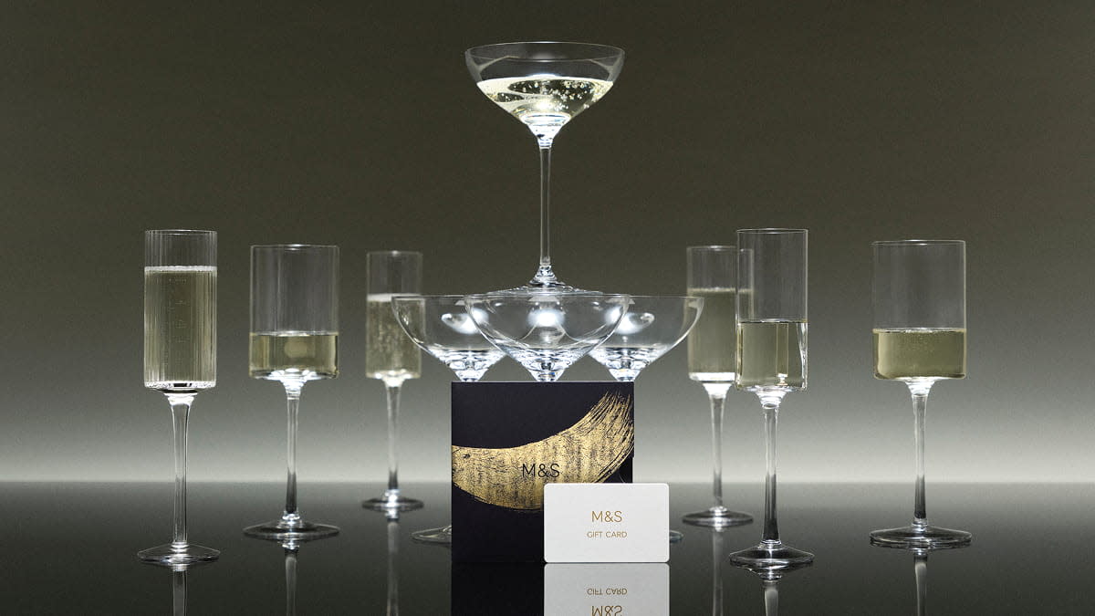 Glasses of sparkling wine with gift card