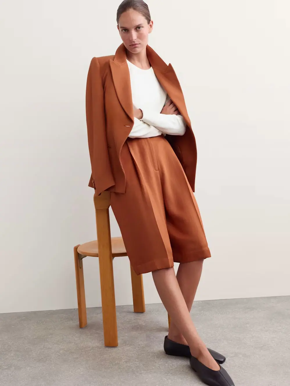 Woman in blazer and long shorts