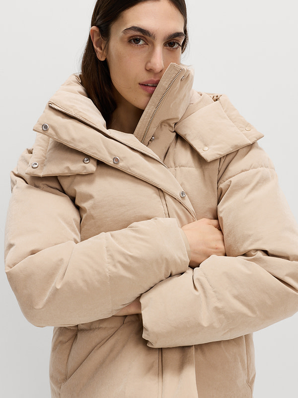 Woman wearing peach Thermowarmth padded puffer jacket