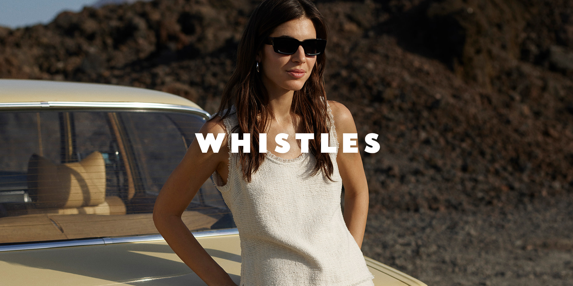 Woman wearing Whistles white top