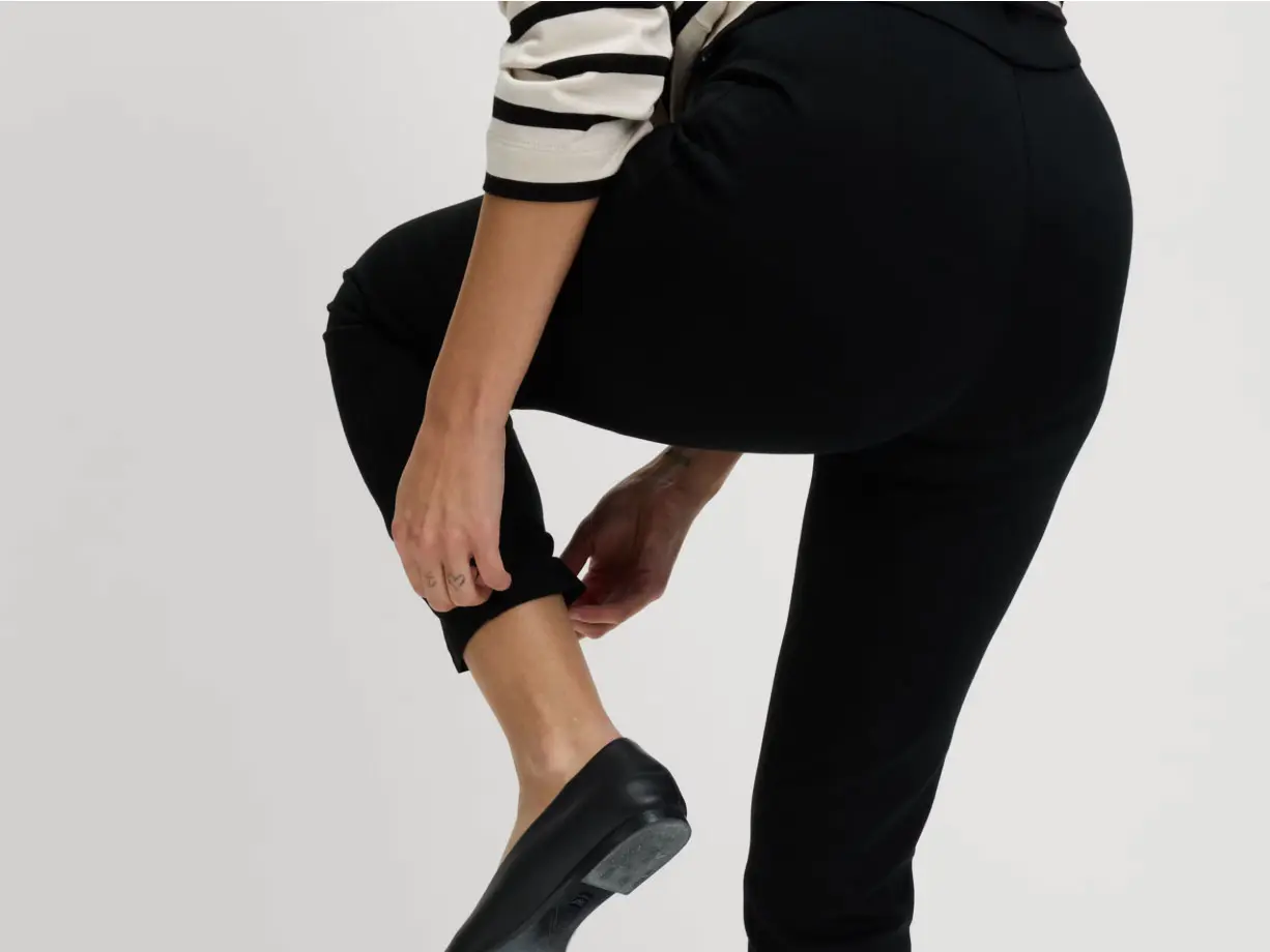 Woman wearing black slim-fit trousers