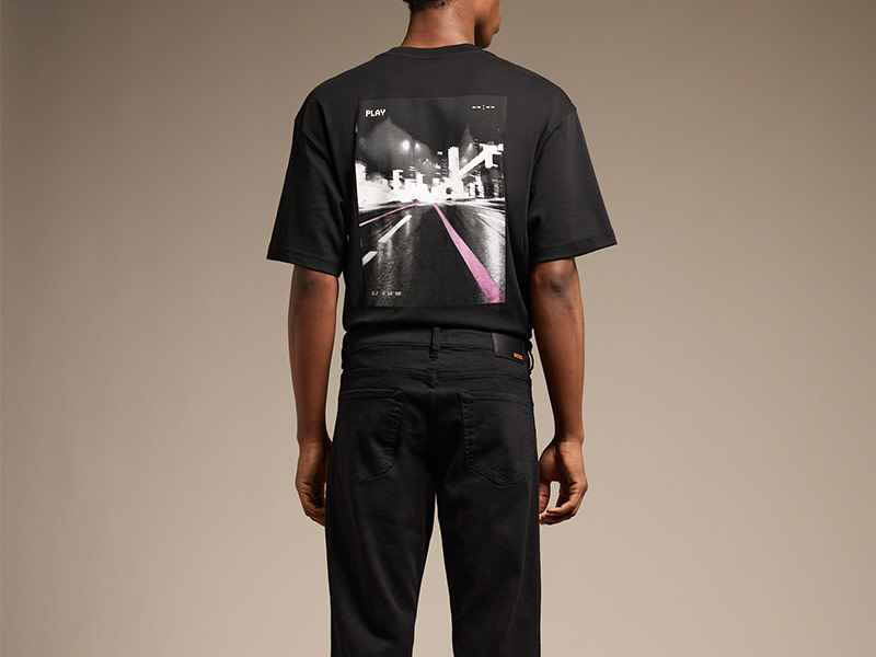 man facing backwards wearing black t-shirt with graphic