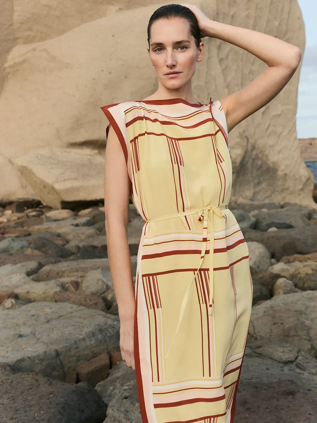 Woman in yellow dress on beach