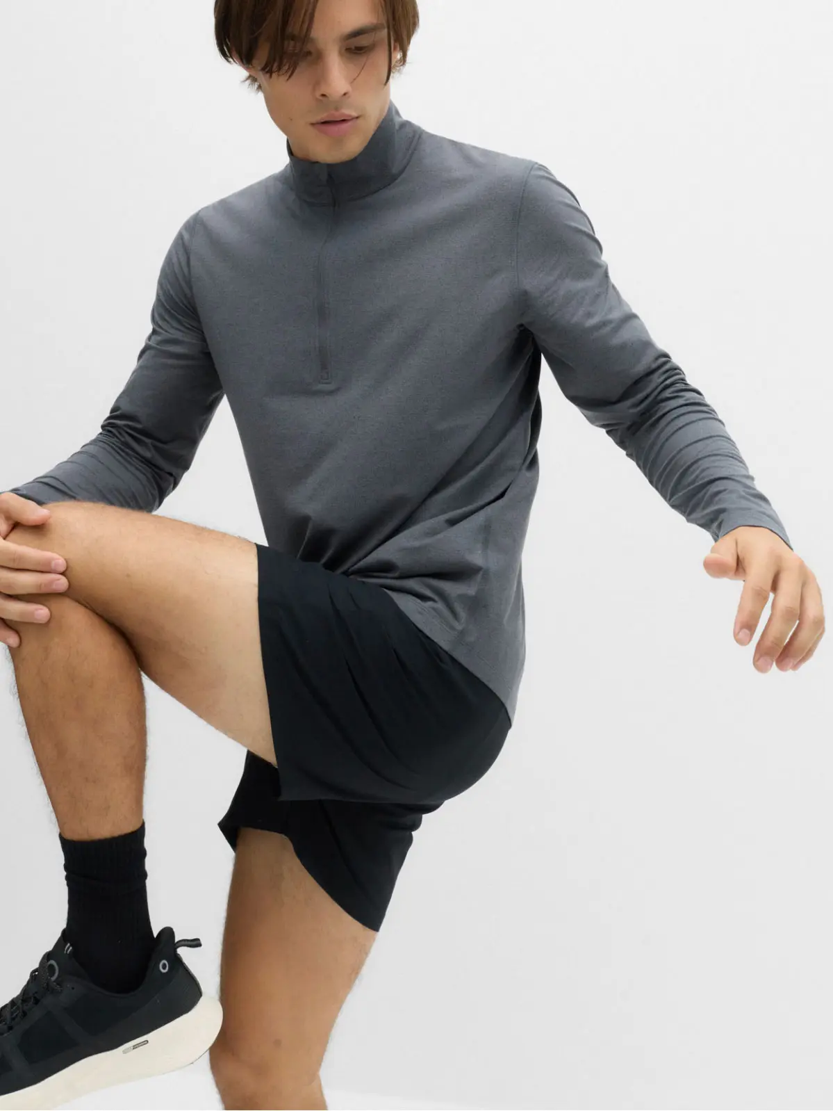 Man wearing sports top and black sports shorts with trainers 