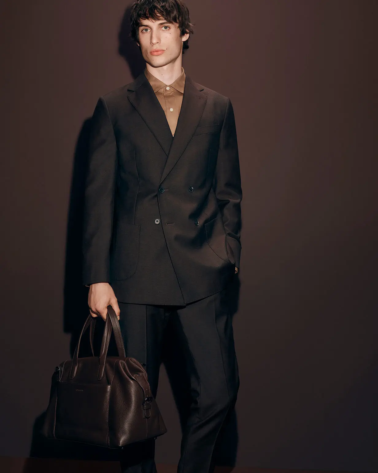 Man wearing dark brown jacket and matching trousers by Autograph