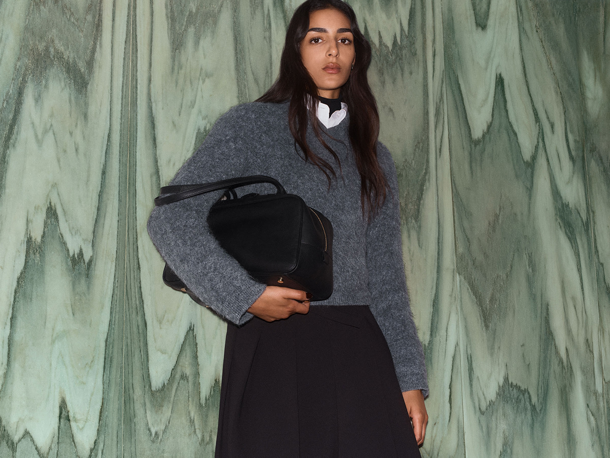 Woman wearing grey jumper