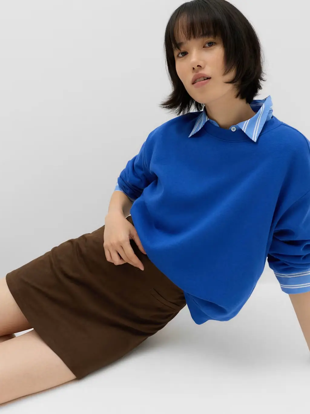 Woman in brown skirt and blue top