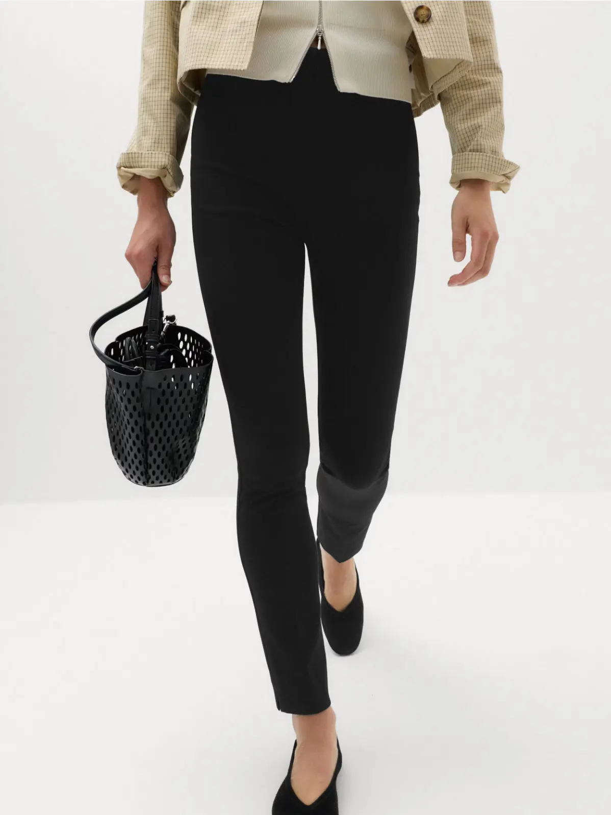 Woman wearing black slim-fit trousers
