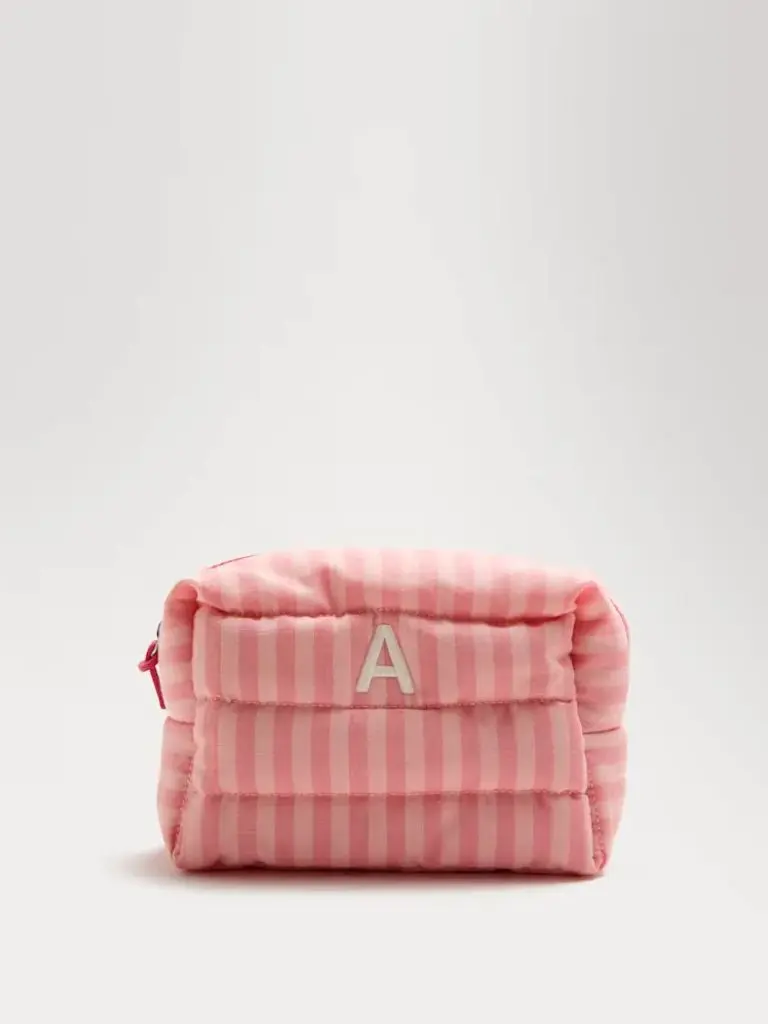 A product shot of a personalised stripe makeup bag with an A on it