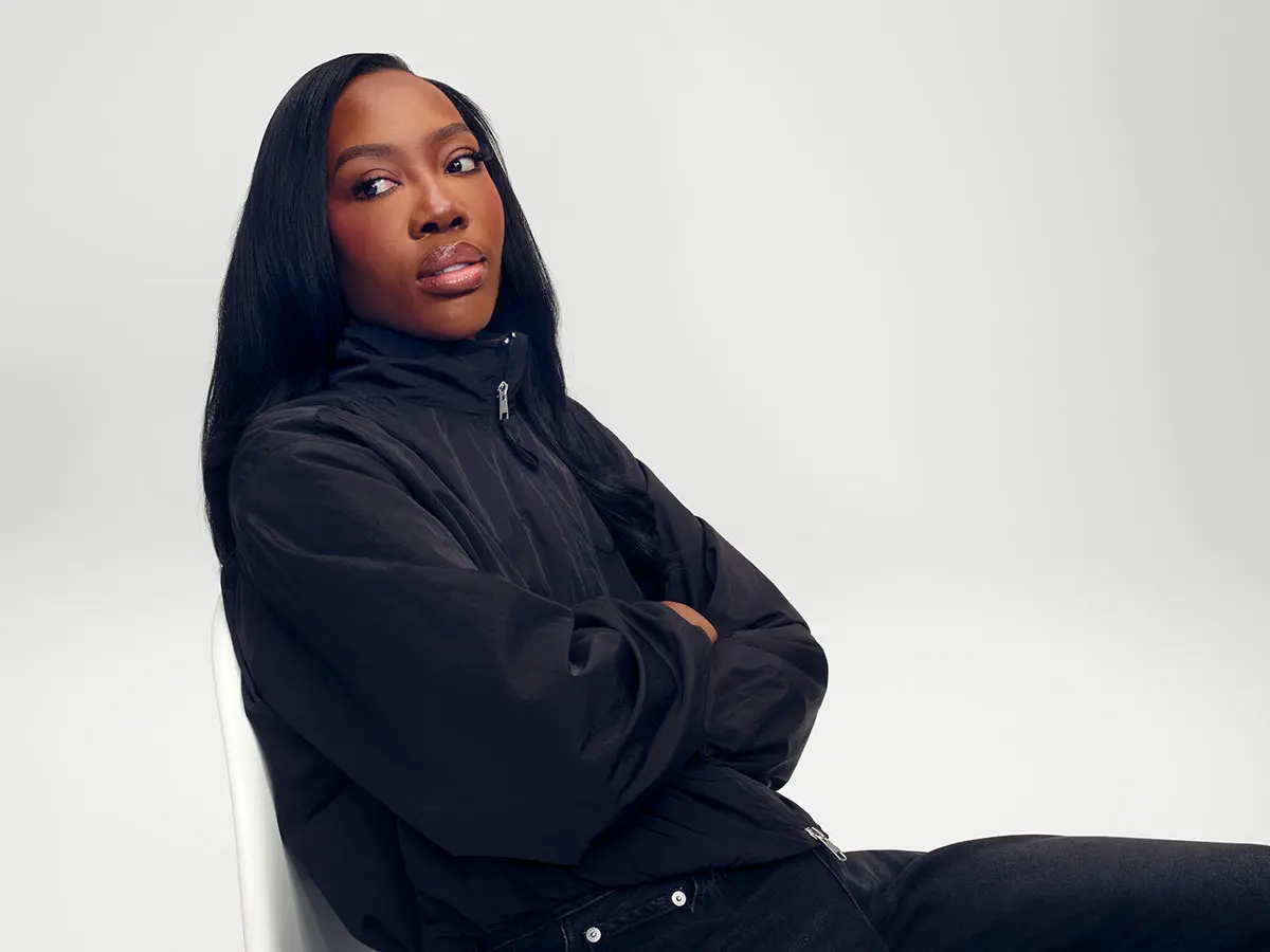 Woman wearing black track-style jacket 